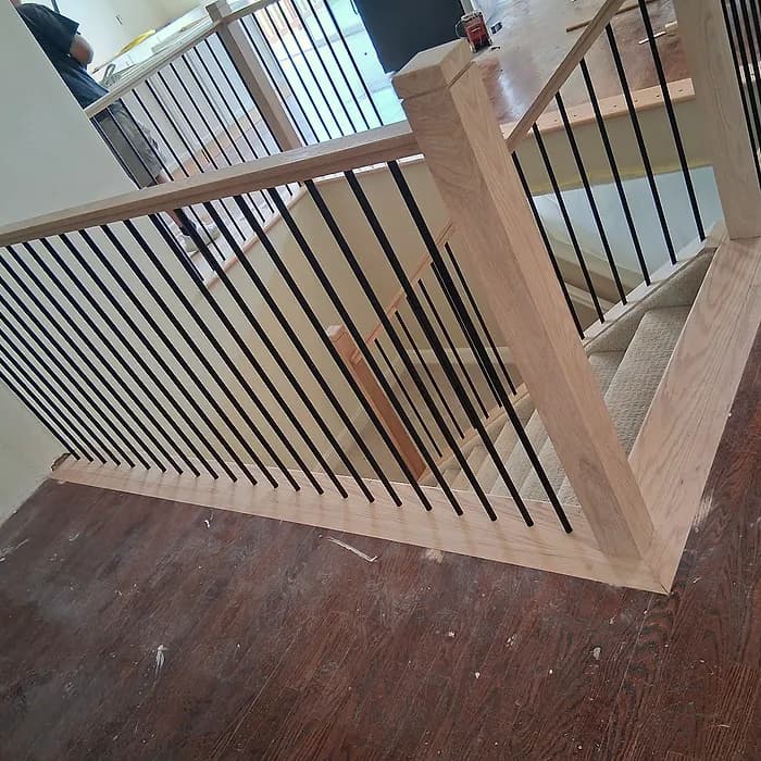 Loft railing with iron balusters overlooking the main floor