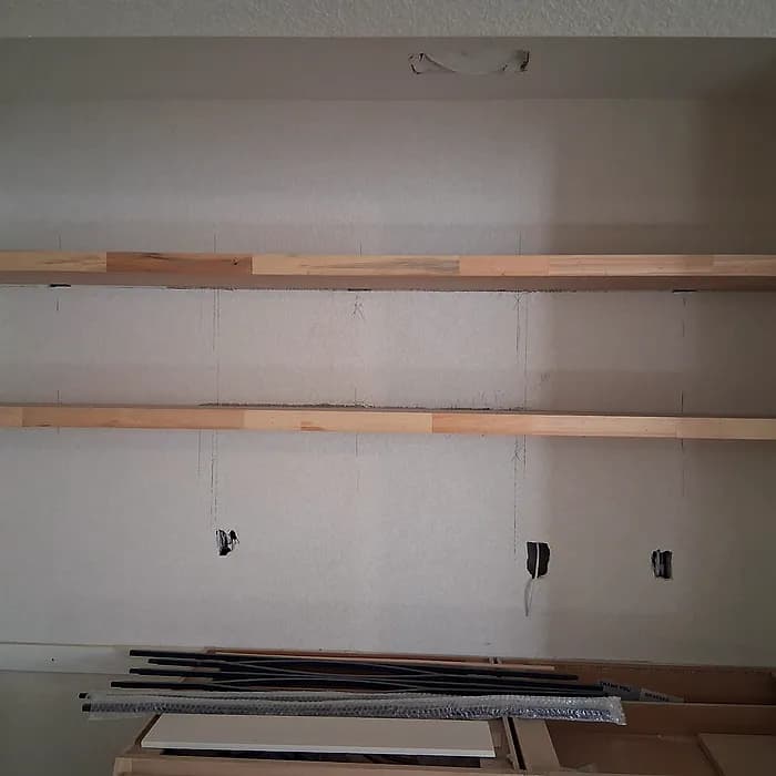 Custom floating wood shelves mounted on a wall
