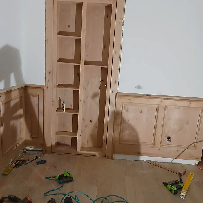 Tall built-in pantry cabinet with wainscoting