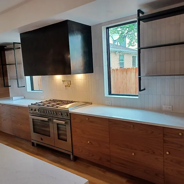 Custom wood kitchen with floating shelves and a range hood